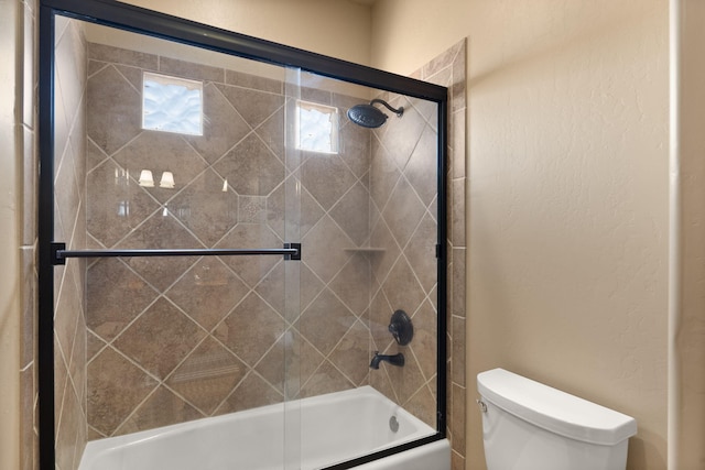 3605 Greystone Ridge Dr SE, Rio Rancho, NM 87124 - full bathroom featuring toilet and bath / shower combo with glass door
