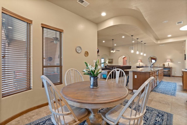3605 Greystone Ridge Dr SE, Rio Rancho, NM 87124 - dining area featuring arched walkways, a ceiling fan, baseboards, light tile patterned flooring, and recessed lighting