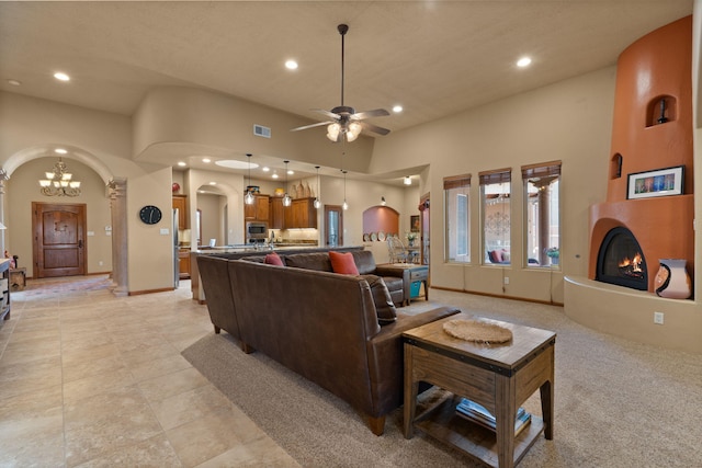 3605 Greystone Ridge Dr SE, Rio Rancho, NM 87124 - living room featuring arched walkways, recessed lighting, ceiling fan, a high ceiling, and a fireplace