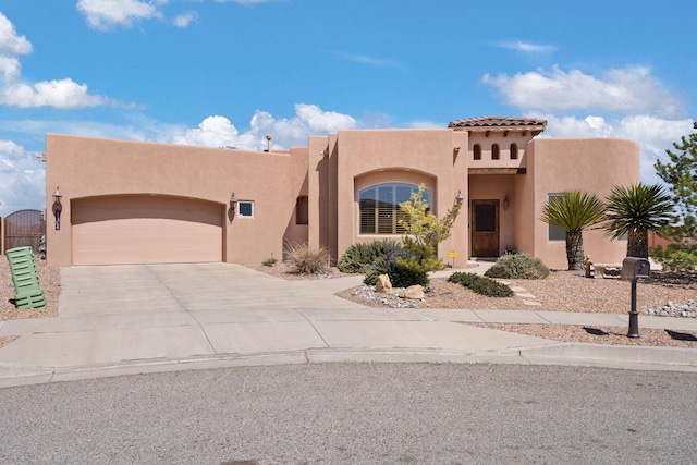 3605 Greystone Ridge Dr SE, Rio Rancho, NM 87124 - view of front of home with stucco siding, a garage, and driveway