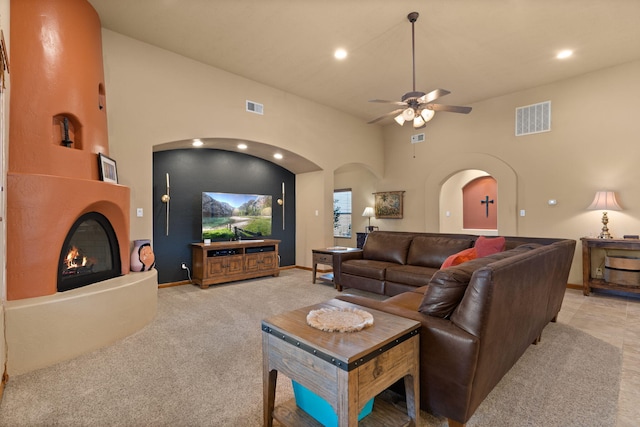 3605 Greystone Ridge Dr SE, Rio Rancho, NM 87124 - living area with arched walkways, a glass covered fireplace, ceiling fan, recessed lighting, and baseboards
