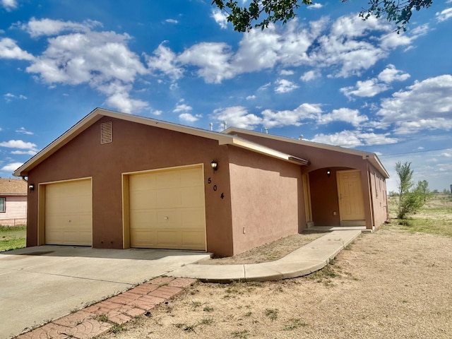504 Maple Ave, Moriarty, NM 87035 - view of property exterior with stucco siding and a garage