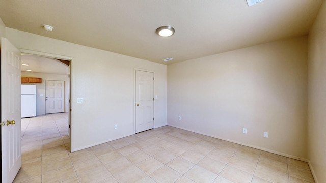 504 Maple Ave, Moriarty, NM 87035 - unfurnished room featuring light tile patterned floors, a smoke detector, baseboards, and arched walkways