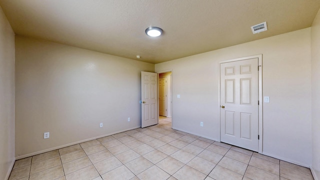 504 Maple Ave, Moriarty, NM 87035 - unfurnished bedroom featuring baseboards and light tile patterned flooring