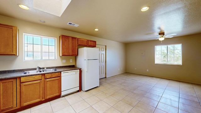 504 Maple Ave, Moriarty, NM 87035 - kitchen featuring white appliances, a sink, dark countertops, brown cabinetry, and recessed lighting