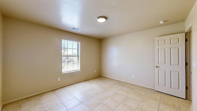 504 Maple Ave, Moriarty, NM 87035 - spare room with light tile patterned floors, a smoke detector, baseboards, and a textured ceiling