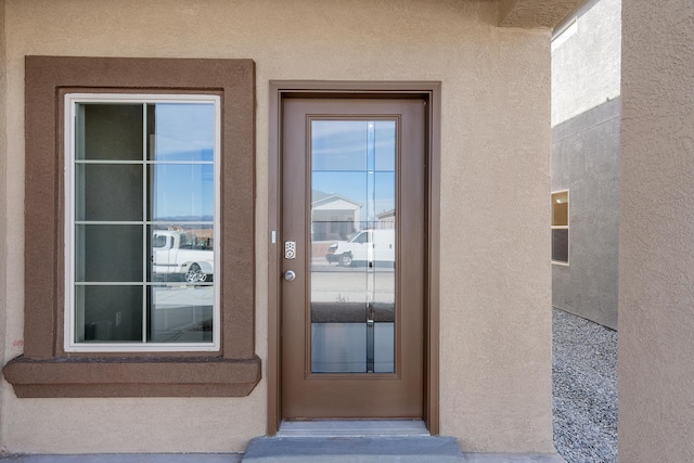 6814 Atherstone Ln NW, Albuquerque, NM 87114 - doorway to property with stucco siding