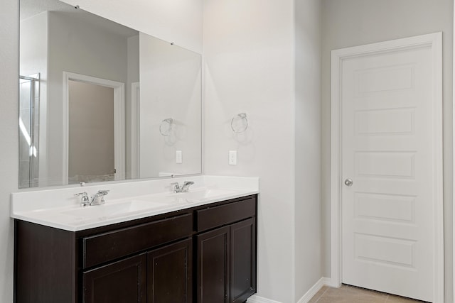 6814 Atherstone Ln NW, Albuquerque, NM 87114 - bathroom with double vanity, baseboards, and tile patterned floors