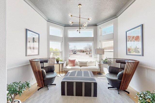 122 Martha Ct, Corrales, NM 87048 - living area featuring an inviting chandelier, a textured ceiling, ornamental molding, and wood finished floors