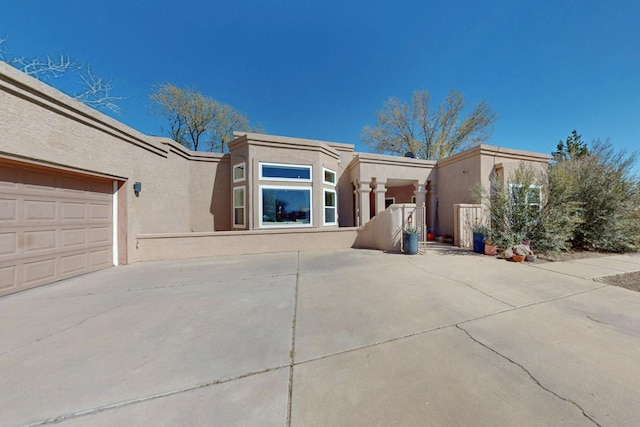 122 Martha Ct, Corrales, NM 87048 - view of front of property with an attached garage, driveway, and stucco siding