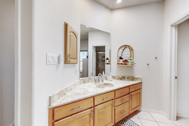 122 Martha Ct, Corrales, NM 87048 - bathroom with tile patterned floors, vanity, and baseboards