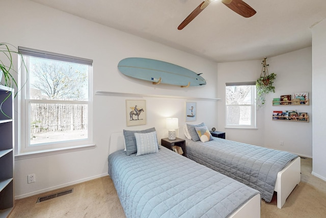 122 Martha Ct, Corrales, NM 87048 - carpeted bedroom with visible vents, baseboards, and ceiling fan