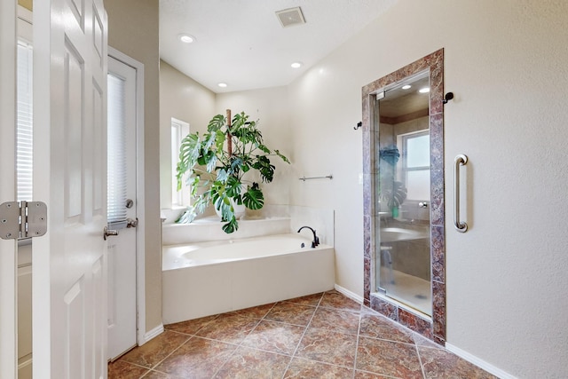 122 Martha Ct, Corrales, NM 87048 - bathroom featuring visible vents, baseboards, a bath, and a stall shower