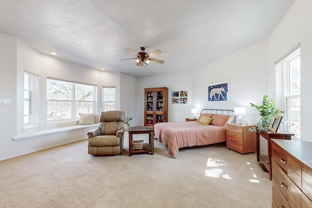 122 Martha Ct, Corrales, NM 87048 - bedroom with ceiling fan, multiple windows, light carpet, and a textured ceiling