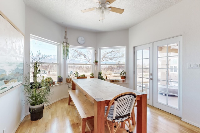 122 Martha Ct, Corrales, NM 87048 - dining room featuring french doors, light wood-style flooring, a ceiling fan, and a textured ceiling