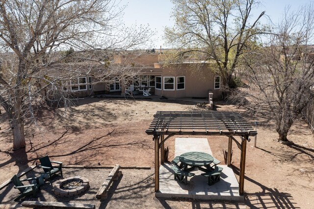 122 Martha Ct, Corrales, NM 87048 - back of house with a patio, stucco siding, and a fire pit