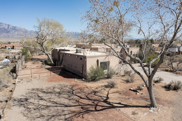 122 Martha Ct, Corrales, NM 87048 - view of home's exterior with a mountain view and stucco siding