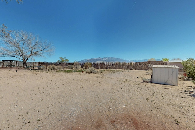 122 Martha Ct, Corrales, NM 87048 - view of yard with an outbuilding, a mountain view, and a shed