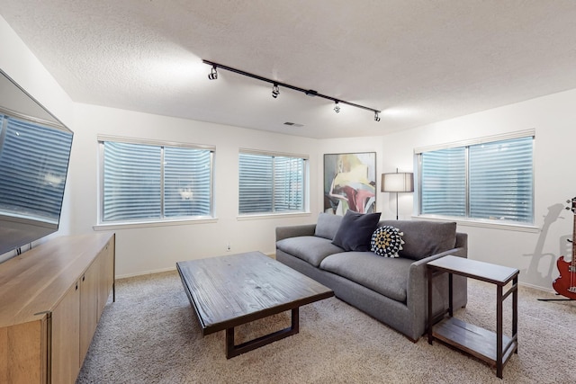 122 Martha Ct, Corrales, NM 87048 - living room with baseboards, visible vents, light colored carpet, and a textured ceiling