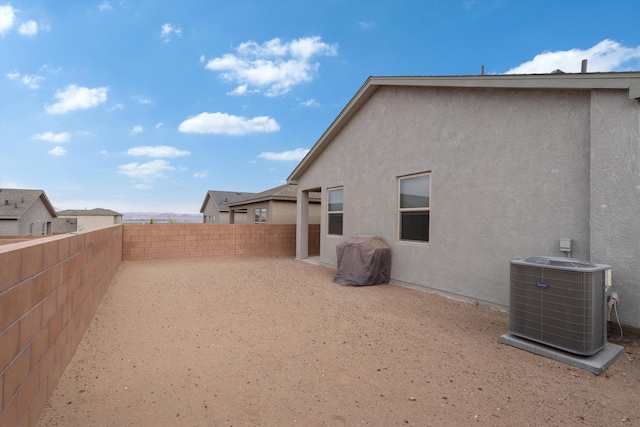 10709 Sabino Loop SW, Albuquerque, NM 87121 - view of yard featuring a fenced backyard, a patio, and cooling unit