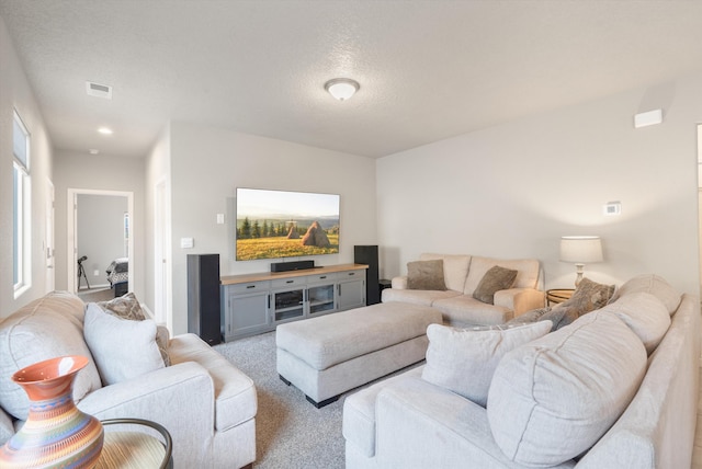 10709 Sabino Loop SW, Albuquerque, NM 87121 - living area with visible vents, a textured ceiling, and light carpet