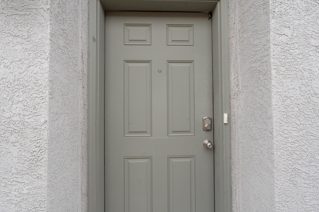 entrance to property with stucco siding