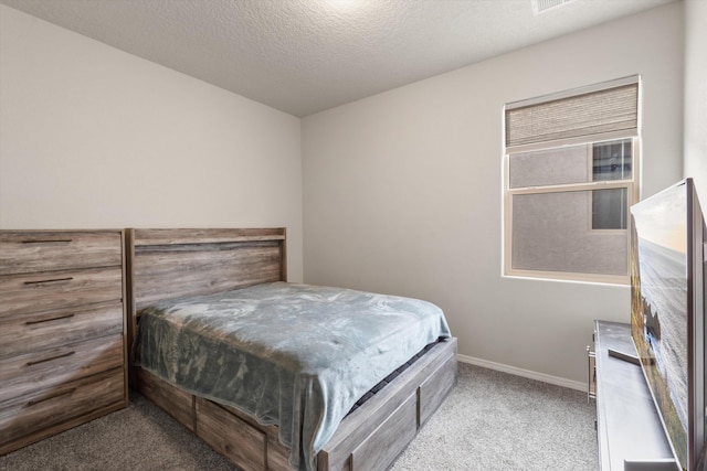 bedroom featuring carpet floors, a textured ceiling, and baseboards