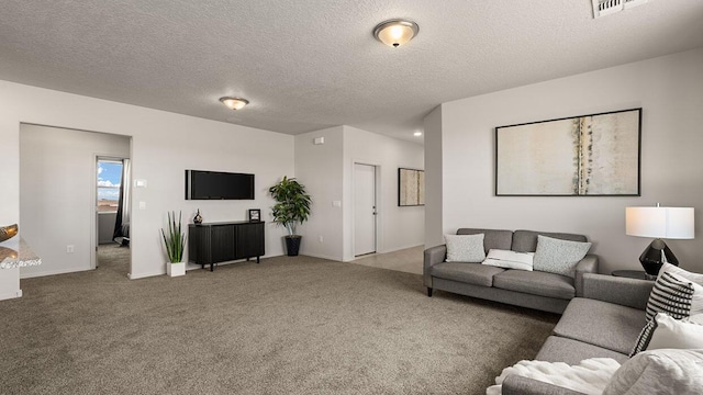 carpeted living room with visible vents and a textured ceiling
