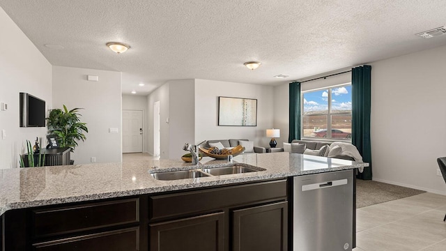 kitchen with visible vents, light carpet, open floor plan, a sink, and dishwasher