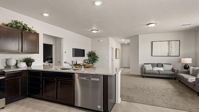 kitchen featuring visible vents, a sink, a peninsula, open floor plan, and stainless steel appliances