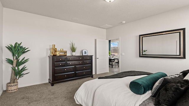 carpeted bedroom featuring baseboards and a textured ceiling