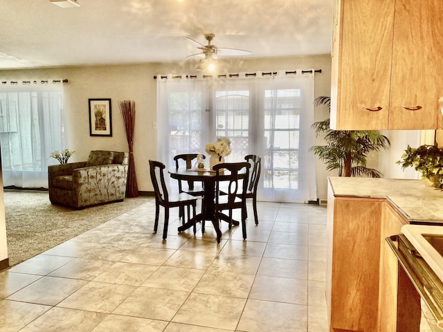dining space featuring light tile patterned flooring, baseboards, and a ceiling fan