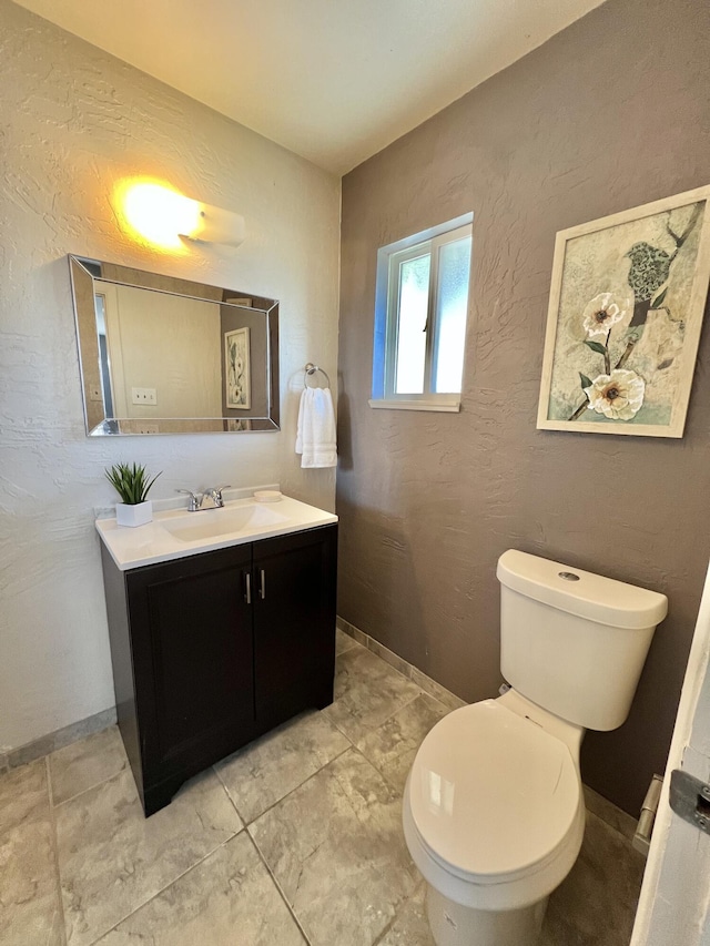half bathroom with toilet and vanity