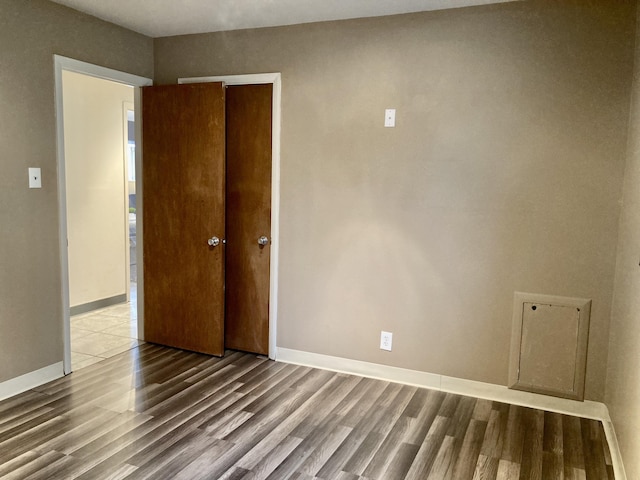 interior space featuring wood finished floors and baseboards