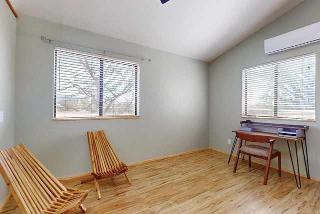 1005 Guadalupe Del Prado St NW, Albuquerque, NM 87107 - home office with baseboards, a wall mounted AC, wood finished floors, and lofted ceiling