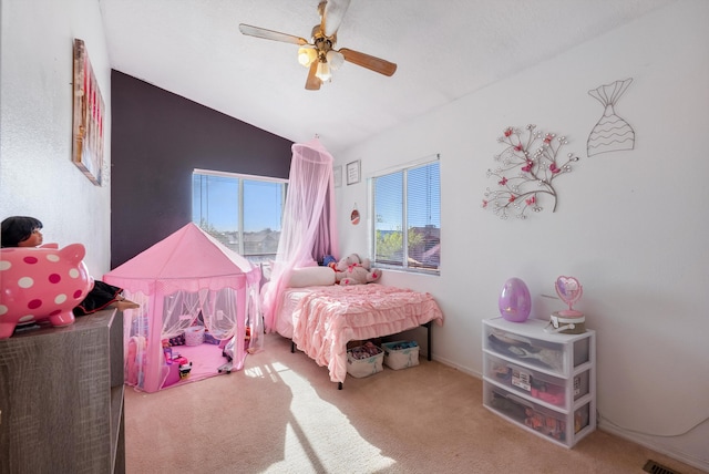 bedroom with ceiling fan, carpet flooring, and vaulted ceiling