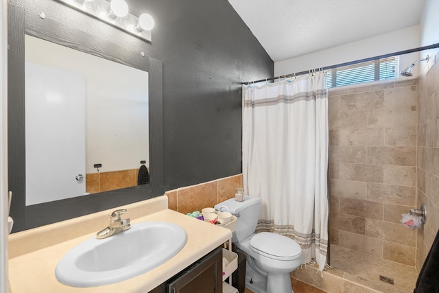 bathroom featuring toilet, a stall shower, and vanity