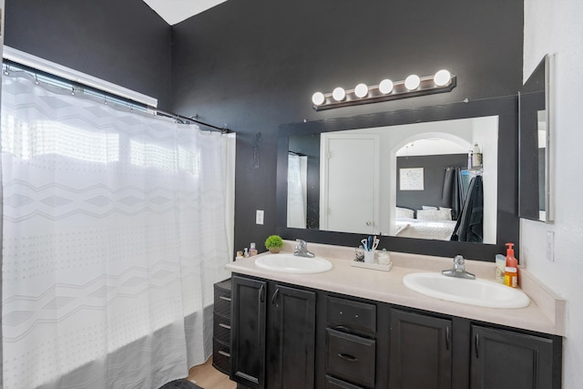 full bathroom featuring connected bathroom, double vanity, a sink, and shower / bathtub combination with curtain