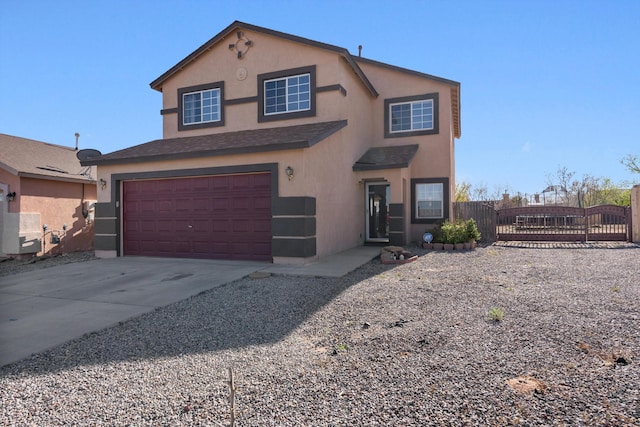 view of front of property with an attached garage, concrete driveway, stucco siding, and fence