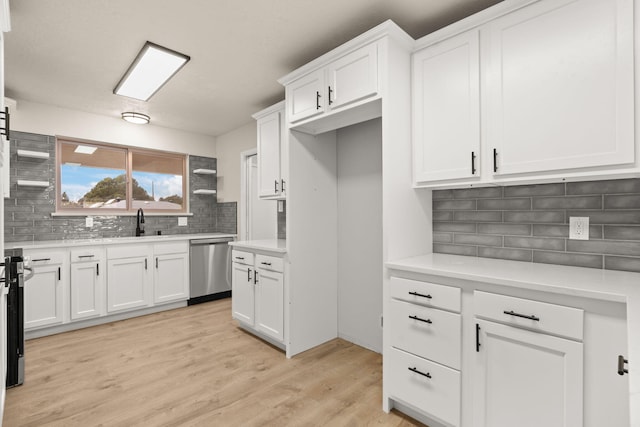 2908 Pennsylvania St NE, Albuquerque, NM 87110 - kitchen featuring decorative backsplash, stainless steel dishwasher, light wood-type flooring, light countertops, and white cabinets