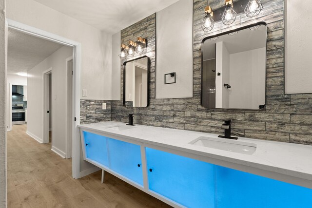 2908 Pennsylvania St NE, Albuquerque, NM 87110 - full bath with a sink, decorative backsplash, double vanity, and wood finished floors