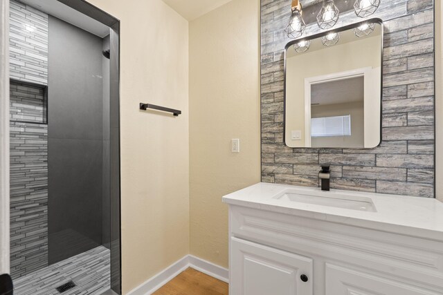 2908 Pennsylvania St NE, Albuquerque, NM 87110 - bathroom with baseboards, a shower stall, wood finished floors, and vanity