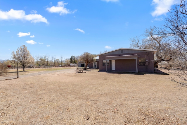 view of yard with fence and driveway