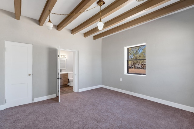 unfurnished bedroom with carpet floors, baseboards, ensuite bathroom, and beamed ceiling