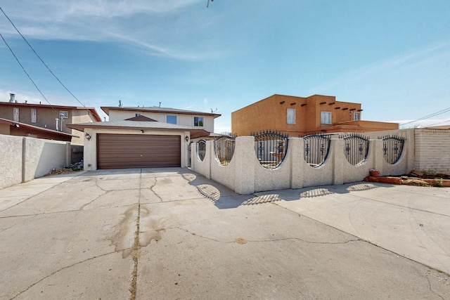 3008 Corona Dr NW, Albuquerque, NM 87120 - view of front of home featuring a garage, a fenced front yard, stucco siding, and concrete driveway