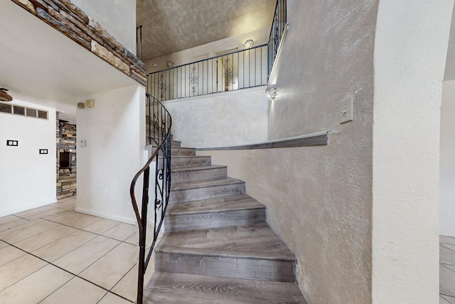 3008 Corona Dr NW, Albuquerque, NM 87120 - staircase featuring a textured wall, visible vents, and tile patterned flooring