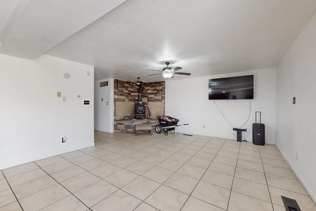 3008 Corona Dr NW, Albuquerque, NM 87120 - unfurnished living room with a ceiling fan, a textured ceiling, and a wood stove