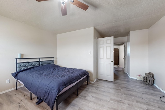 3008 Corona Dr NW, Albuquerque, NM 87120 - bedroom featuring a textured ceiling, baseboards, ceiling fan, and light wood-style floors