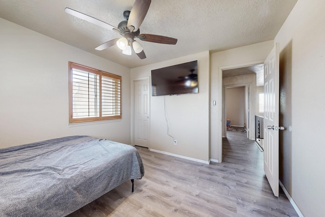 3008 Corona Dr NW, Albuquerque, NM 87120 - bedroom featuring baseboards, a ceiling fan, a textured ceiling, and light wood-style flooring