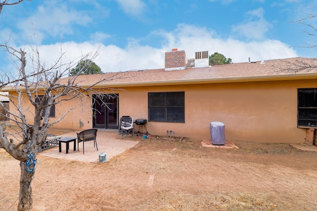 324 Aragon Ave, White Rock, NM 87547 - back of house featuring a patio, stucco siding, a fenced backyard, and a chimney